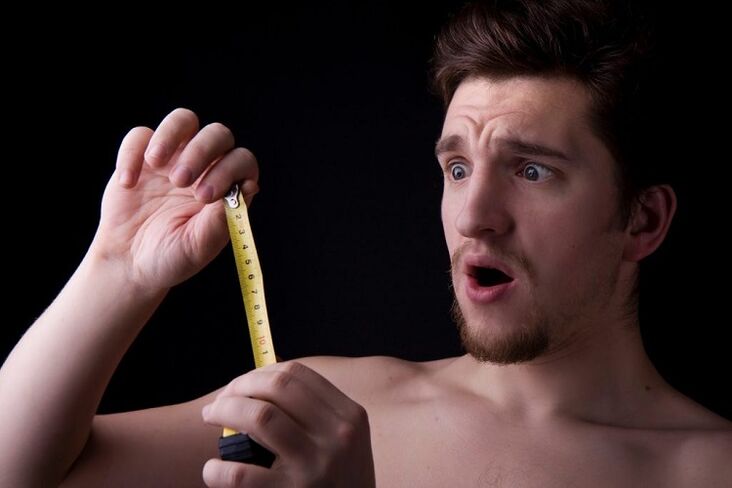 a man with a tape measure measured his penis before surgery for enlargement
